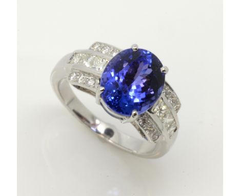 Tanzanite and diamond dress ring, oval cut tanzanite estimated weight 5.18 carats, princess cut and round cut diamonds set in