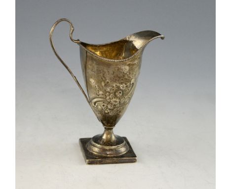 George III silver helmet shaped cream jug, with embossed decoration, on square foot, probably London, 1786, marks rubbed, bas