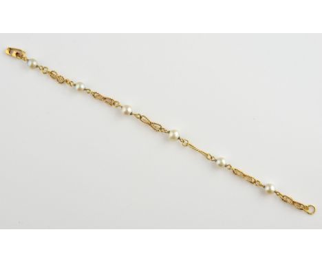 Cultured pearl, bracelet of six pearls connected by twist fancy links, marks unclear, yellow metal testing as 14 ct, length 1
