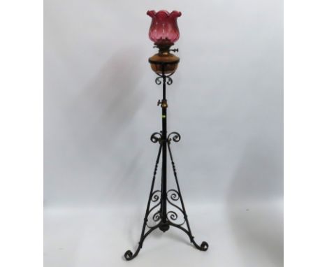 A rise & fall oil lamp with cranberry shade, 1600mm