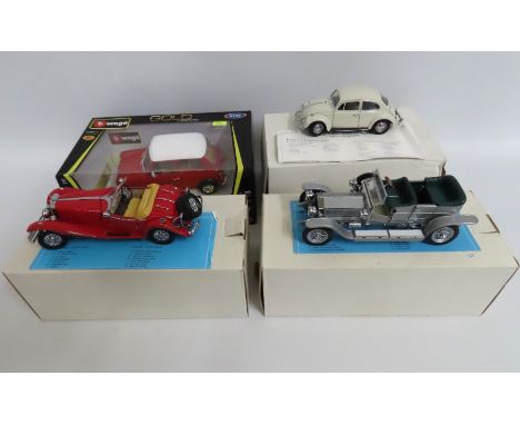 A Burago 1:18 1969 Mini Cooper twinned with a 1967 VW Beetle model, a Franklin Mint Mercedes 500 Special Roadster, fault to p