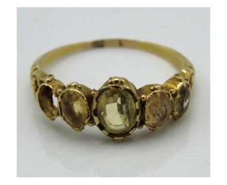 A yellow metal antique ring set with citrine, tests electronically as 14ct gold, loss of one stone, 2.2g, size R