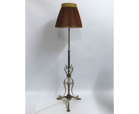 A decorative brass lamp with silk shade, 1700mm tall 