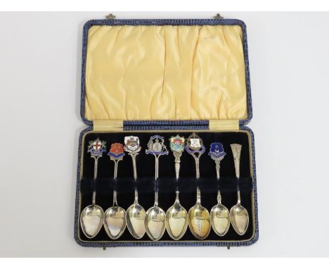 A cased set of eight silver tourist type spoons with enamelled tops dating from 1908 onward, Barnard Castle has fault to enam