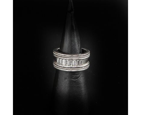 Set with 8 baguette cut diamonds, ring size 17.