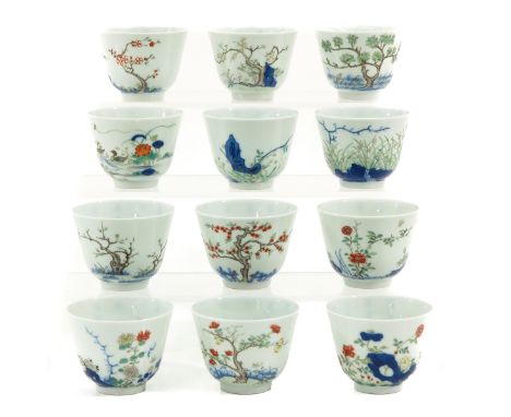 Depicting scene in garden with flower blossoms in trees and Chinese text, Kangxi mark, 5 cm. tall x 6 cm. in diameter, chip.