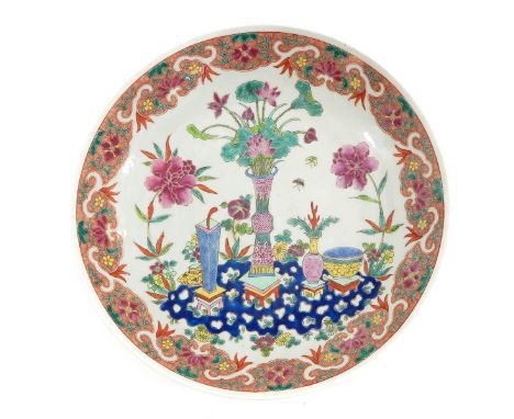 Depicting Chinese antiquities in center of charger with floral decor border, Kangxi mark, 34 cm. in diameter.