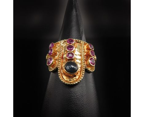 Set with 11 faceted rubies and 1 cabochon cut sapphire, ring size 17.5.