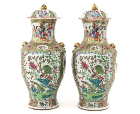 Floral ground with butterflies, depicting gathering of Chinese figures, 60 cm. tall, one vase restored.