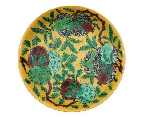 Yellow sgraffito ground with decor of fruit on vine, Kangxi mark, 25 cm. in diameter.