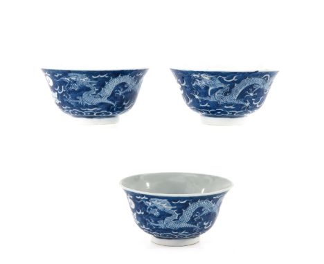 Dark blue ground with white dragon and clouds, Kangxi mark, 9 cm. in diameter, baking fault.