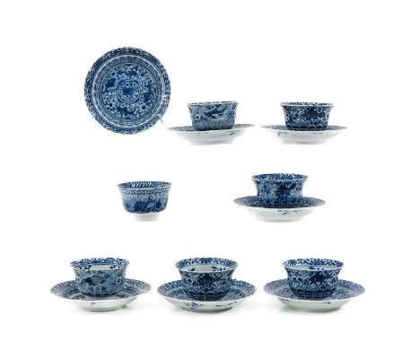 Depicting sea creatures, including 7 cups and saucers, Kangxi mark, saucers are 13 cm. in diameter, chip and hairline.