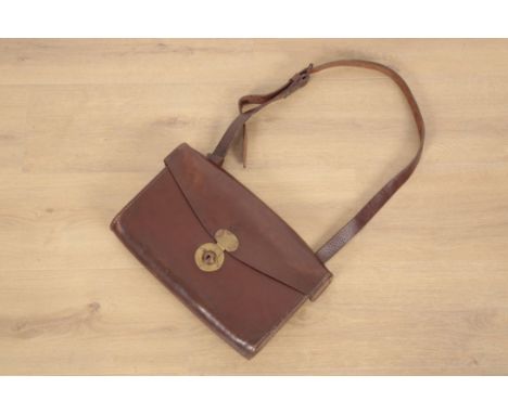AN EDWARDIAN BROWN LEATHER SATCHEL with leather carrying strap, brass locks, stamped with the Royal Crown and "G. R." to the 