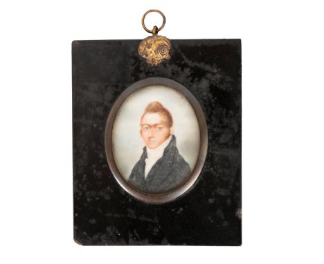 EARLY 19TH CENTURY SCHOOL, Miniature shoulder length portrait of a young man with quiffed hair painting on ivory, oval 6.2cm 