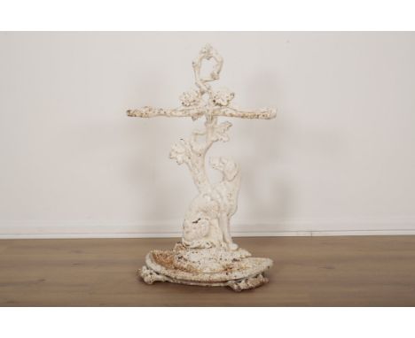 A VICTORIAN CAST IRON WHITE-PAINTED STICK STAND modelled with a hound beneath a tree, a drip pan beneath, 72.5cm high