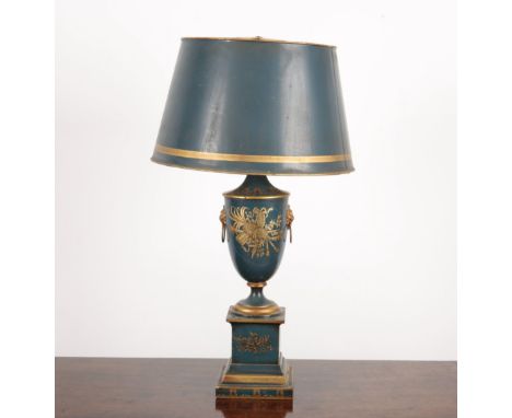 A FRENCH TOLEWARE LAMP the baluster body decorated in gilt with musical trophies to each side, lions head ring handles to the