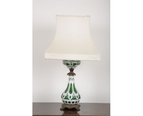 A 19TH CENTURY BOHEMIAN WHITE AND GREEN FLASHED GLASS LAMP with leaf and flower cuttings, circular reservoir and baluster ste
