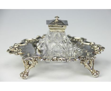 A Victorian glass and silver ink well and stand, H Wilkinson and Co, Sheffield 1852, the square section base with florally ca