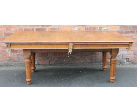 An early 20th century E. J. Riley oak snooker dining table, model A61634, with four leaves, on turned and fluted legs, 76cm H