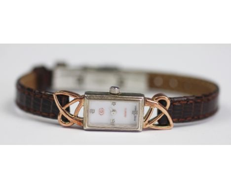 A ladies Clogau wristwatch the rectangular face with attached Celtic detail and with stone set face, case stamped 'Clogau Ser