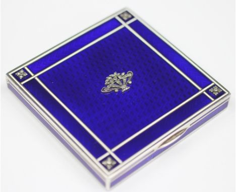A French imported silver and blue enamel compact, probably Vienna, stamped  'R.S' , the cover decorated with a basket of flow