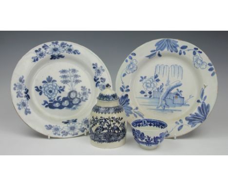 Two Delft plates, each decorated with a floral and rock work deisgn in cobalt, 23cm diameter, with a Caughley tea bowl printe
