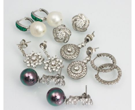 A collection of assorted earrings, to include; a pair of CZ and silver pearl effect drop earrings, a pair of drop 'snowflake'