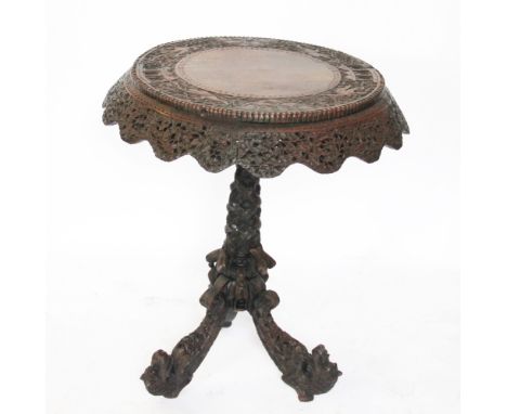 A 19th century Anglo-Indian carved hardwood circular occasional table, colonial Burmese, decorated throughout with foliate an