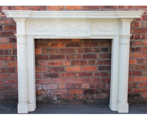 A 19th century Adam style Neo Classical design fire surround, carved wood and gesso, the central panel with trophies of arms,