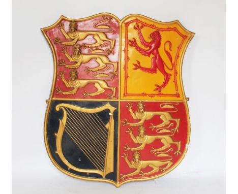 A moulded and painted plaster Royal Arms armorial shield, with quartered lion, harp and three lions, 89cm x 80cm