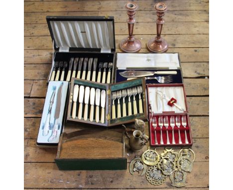 A collection of brass and ceramic and brass horse brasses, some with leather backings, with a pair of 19th century copper can