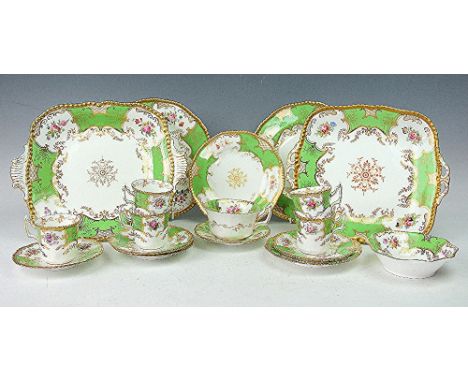 A Coalport green batwing part tea service, each piece decorated in gilt against a partially green ground with floral decorati