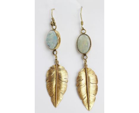 A pair of opal set 'feather' drop earrings by Michael Kirk, designed as a cabochon opal drop suspending a yellow metal 'feath