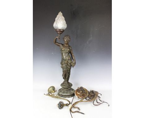 A French bronzed spelter figural table lamp, modelled as a maiden holding a torch with 'flame' shade, 87cm H, with another fl