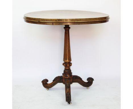 A Victorian inlaid walnut oval occasional table, with fluted and turned column on carved tripod base, fitted castors, 78cm H 