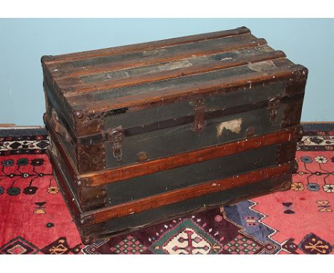 A late 19th century wood and canvas mounted travelling trunk, 45cm H x 77cm W x 43cm D