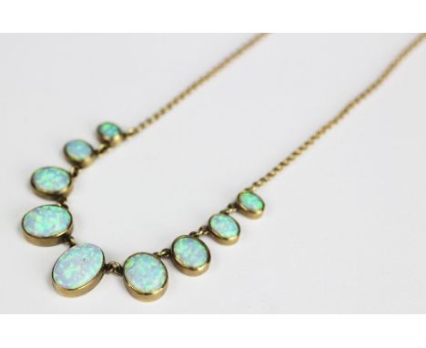 An opal necklace, the nine graduated oval synthetic opals each collet set and with attached 9ct gold fine chain, 42cm long, w