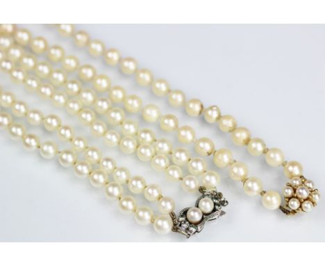 A single strand cultured pearl necklace, with attached pearl set cluster clasp stamped '375', 39cm long and a further two str
