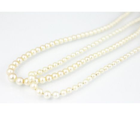 A single strand graduated cultured pearl necklace with attached white metal navette shaped clasp and another similar set (2) 