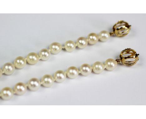 A Mikimoto pearl necklace, the single strand of uniform cultured pearls (of approx 6mm diameter) set to an orb clasp bearing 