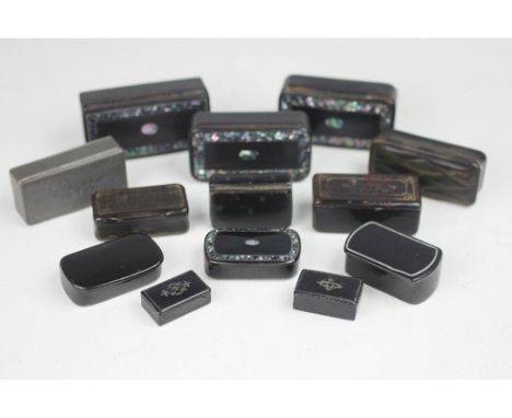 A collection of ten 19th century lacquered papier mache snuff boxes, the largest 8cm, with two pressed horn snuff boxes and a