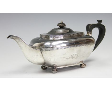 A silver teapot, Thomas Bradbury & Sons Ltd, Sheffield 1914, of rounded rectangular form and on bun feet, ebonised handle and