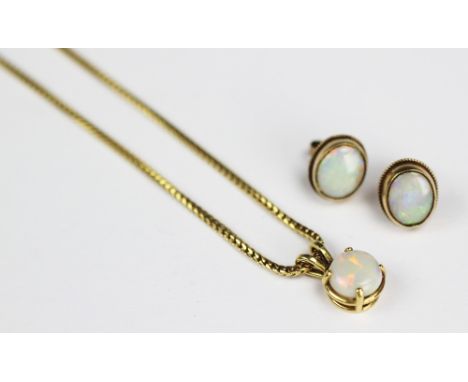 An opal pendant and chain and a pair of opal earrings, designed as a single opal pendant within yellow metal mount stamped '1