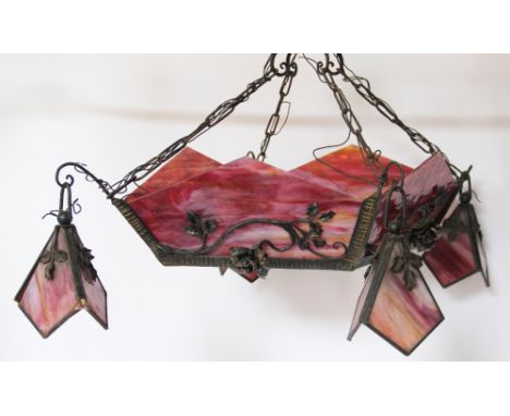 An Art Deco wrought iron ceiling light in the manner of Edgar Brandt, of diamond shape and decorated with roses, with four su
