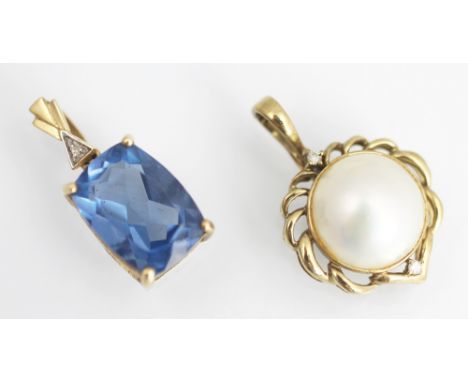 A mabe pearl and diamond set circular pendant/enhancer, within decorative scroll yellow metal surround along with a blue ston