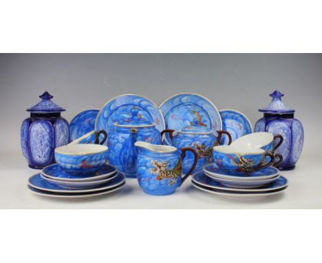 A Japanese eggshell tea or saki service, each piece decorated in a blue wash with a scaley dragon, comprising pot and cover, 