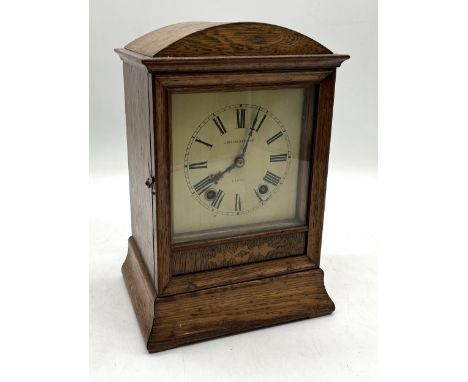An Edwardian oak cased mantle clock by Barraclough & Sons, Leeds