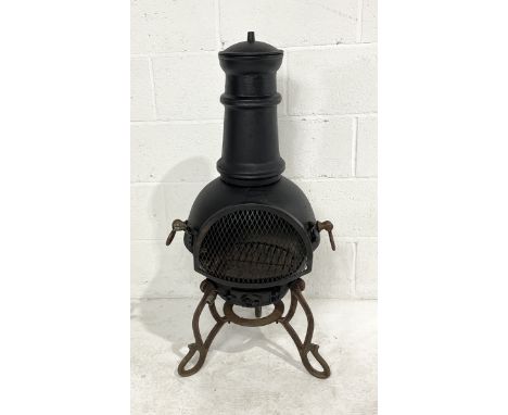 A cast iron chiminea on tripod base - 97cm high