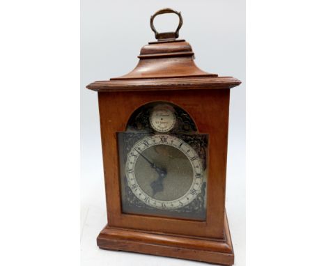 An oak cased bracket clock with brass handle by F Evans, 23cm high.