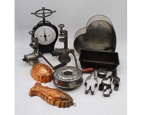 A quantity of various vintage kitchenalia, including jelly moulds, cookie cutters, mincers, scales etc.